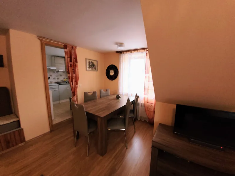 Jídelní stůl a průhled do kuchyňky